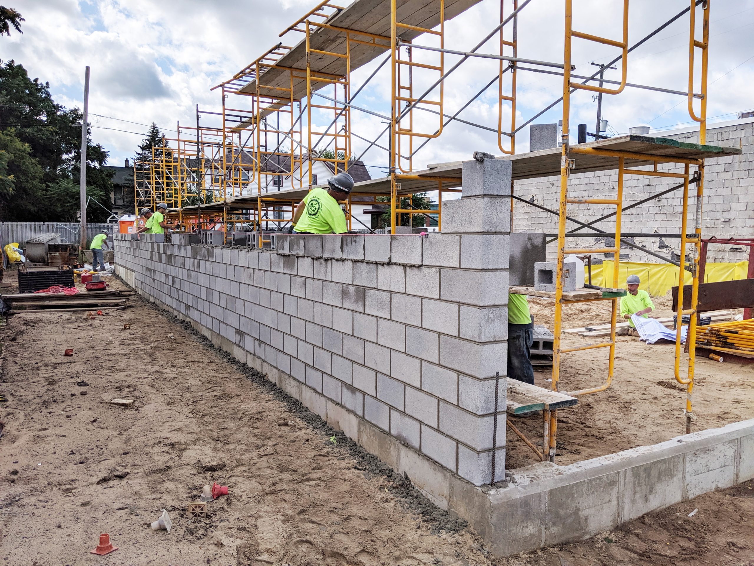 Construction team building a wall